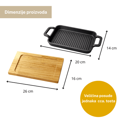 Tava od lijevanog željeza na drvenoj dasci